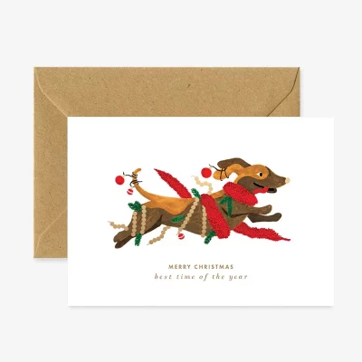 Petit chien enjoué sur carte de vœux Noël, format A6, papier blanc naturel.