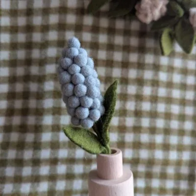 Fleur de jacinthe bleu ciel de Gry & Sif en feutre de laine dans un soliflore. Fleur artificielle de jacinthe bleu ciel avec un feuillage vert.